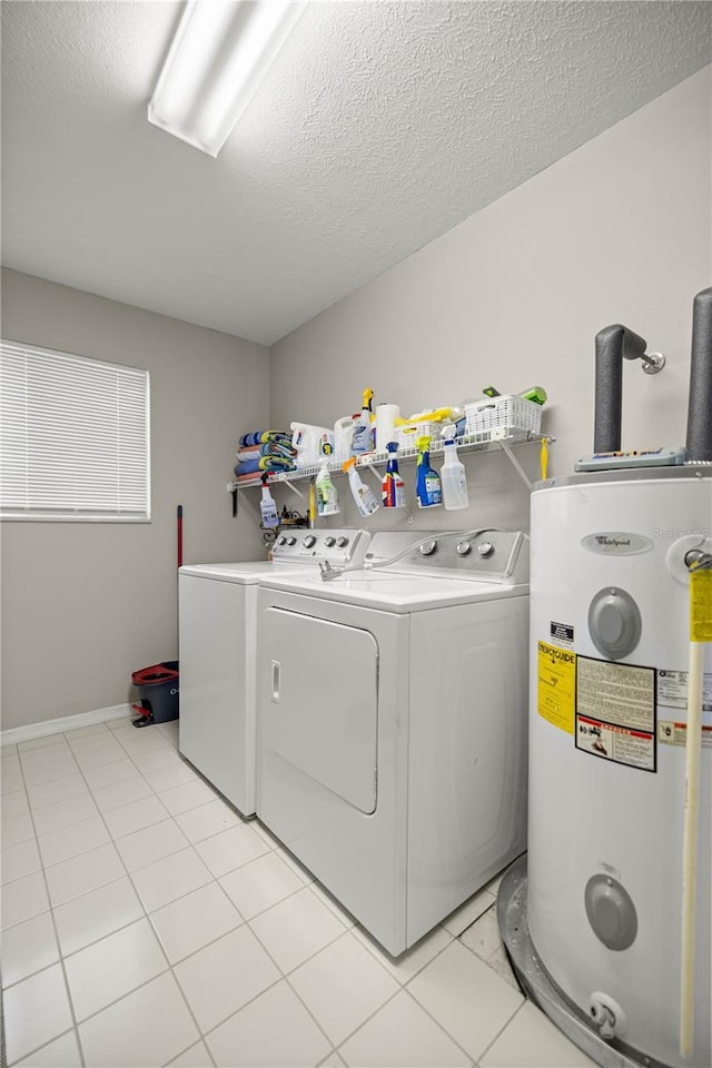 11326 SE 175th Pl, Summerfield, FL 34491 - washroom featuring water heater, washer and dryer, light tile patterned floors, a textured ceiling, and baseboards