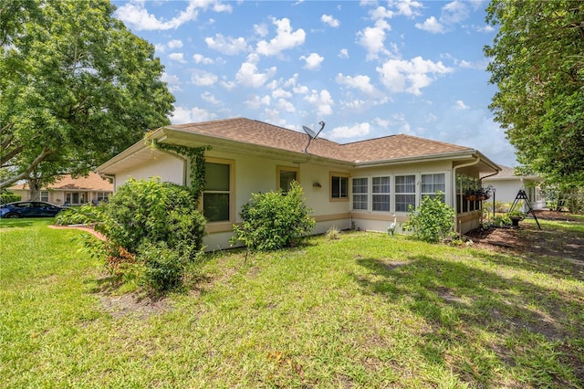 11326 SE 175th Pl, Summerfield, FL 34491 - rear view of property with stucco siding and a yard