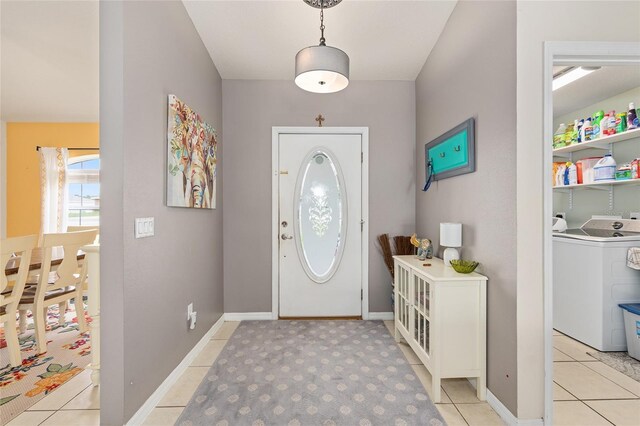 63 Walnut Crse, Ocala, FL 34480 - foyer featuring washer / dryer, light tile patterned flooring, and baseboards