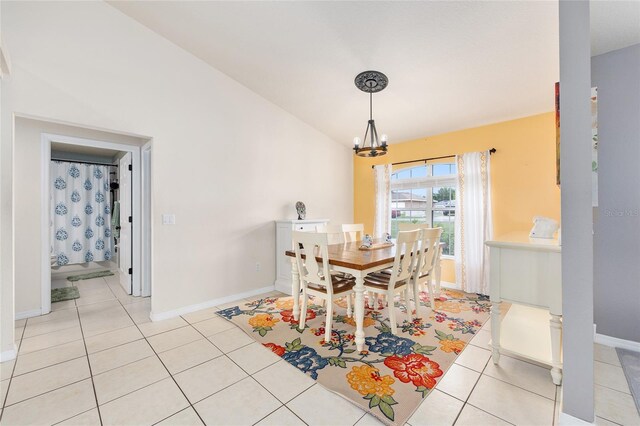 63 Walnut Crse, Ocala, FL 34480 - dining area with a chandelier, baseboards, vaulted ceiling, and light tile patterned flooring