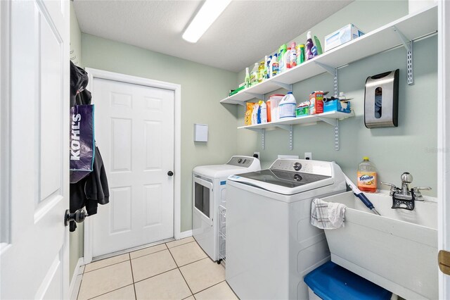 63 Walnut Crse, Ocala, FL 34480 - laundry area featuring washing machine and dryer, light tile patterned floors, and baseboards