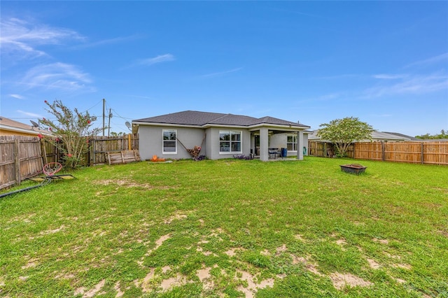 63 Walnut Crse, Ocala, FL 34480 - rear view of property with a fire pit and stucco siding