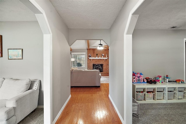 986 SE 57th Ave, Ocala, FL 34480 - hall with a textured ceiling, wood-type flooring, and baseboards