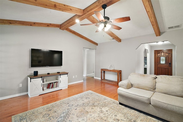 986 SE 57th Ave, Ocala, FL 34480 - living room featuring a ceiling fan, light wood finished floors, arched walkways, and baseboards