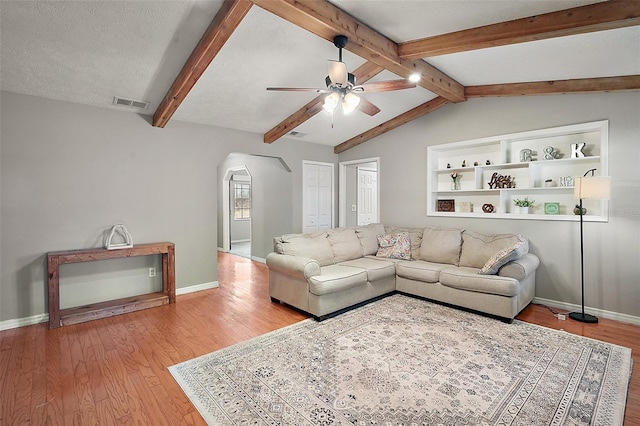 986 SE 57th Ave, Ocala, FL 34480 - living room featuring ceiling fan, arched walkways, light wood-style floors, and baseboards