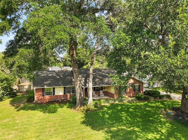 986 SE 57th Ave, Ocala, FL 34480 - view of front of property featuring a front yard, brick siding, and a porch