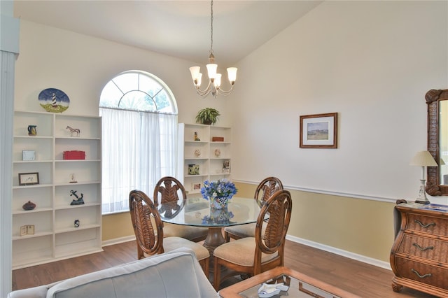 2478 NW 50th Ave, Ocala, FL 34482 - dining area with a chandelier, wood finished floors, and lofted ceiling