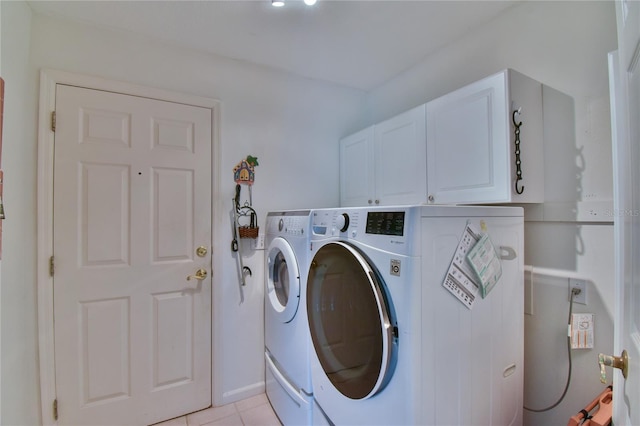 2478 NW 50th Ave, Ocala, FL 34482 - laundry area featuring cabinet space, washing machine and dryer, and light tile patterned floors