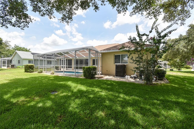 2478 NW 50th Ave, Ocala, FL 34482 - back of house with a yard, stucco siding, an outdoor pool, and a lanai