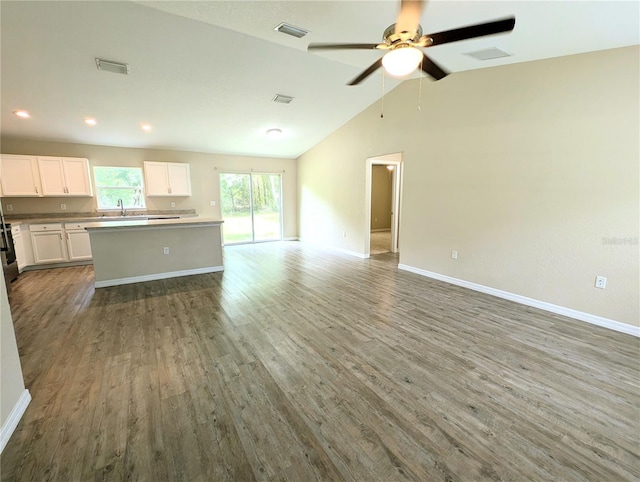 13921 SW 108th Ln, Dunnellon, FL 34432 - unfurnished living room with wood finished floors, baseboards, lofted ceiling, ceiling fan, and recessed lighting