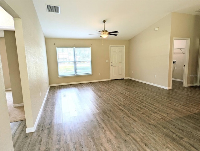 13921 SW 108th Ln, Dunnellon, FL 34432 - unfurnished living room with wood finished floors, a ceiling fan, vaulted ceiling, and baseboards