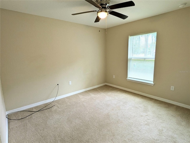 13921 SW 108th Ln, Dunnellon, FL 34432 - spare room with a smoke detector, carpet flooring, baseboards, and a ceiling fan