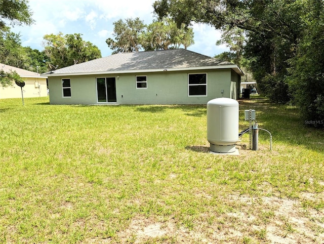 13921 SW 108th Ln, Dunnellon, FL 34432 - back of property featuring a yard and stucco siding