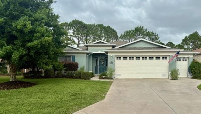 16023 SW 14th Avenue Rd, Ocala, FL 34473 - ranch-style house featuring a garage, driveway, a front lawn, and stucco siding