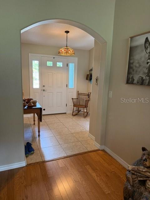 16023 SW 14th Avenue Rd, Ocala, FL 34473 - entrance foyer featuring arched walkways, baseboards, and light wood-style flooring