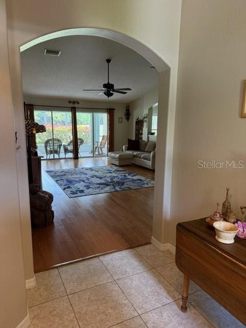 16023 SW 14th Avenue Rd, Ocala, FL 34473 - hall featuring arched walkways, light tile patterned floors, and baseboards