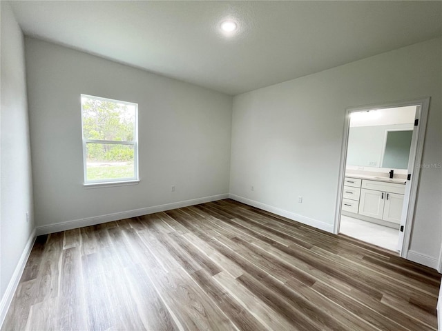 142 Guava Pass, Ocklawaha, FL 32179 - empty room featuring wood finished floors, baseboards, a sink, and recessed lighting