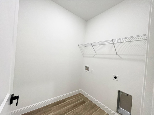142 Guava Pass, Ocklawaha, FL 32179 - laundry room featuring washer hookup, wood finished floors, electric dryer hookup, and baseboards