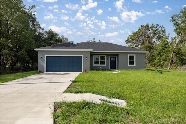 75 Guava Ter, Ocklawaha, FL 32179 - view of front of home with stucco siding, a garage, a front lawn, and concrete driveway
