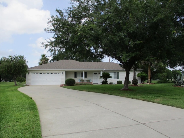 14695 SW 112th Cir, Dunnellon, FL 34432 - ranch-style home with a front yard, a garage, and driveway
