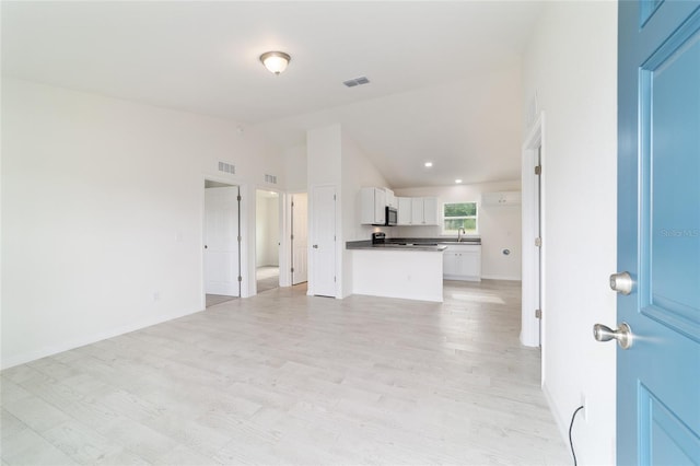 37 Teak Run, Ocala, FL 34472 - unfurnished living room with vaulted ceiling and light wood-type flooring