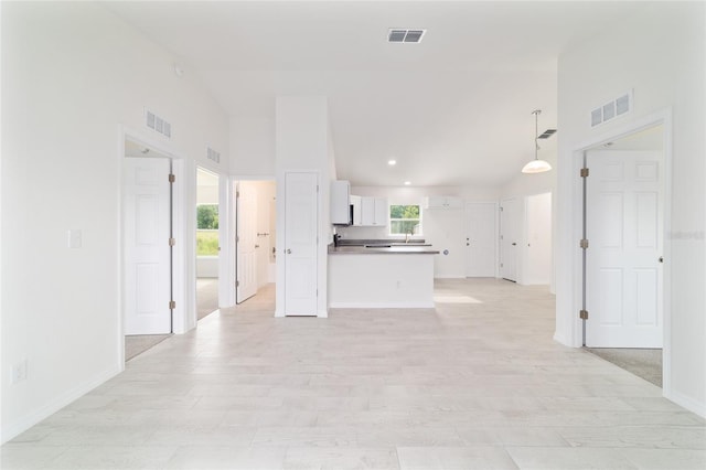 37 Teak Run, Ocala, FL 34472 - kitchen featuring white cabinets, a peninsula, open floor plan, recessed lighting, and dark countertops