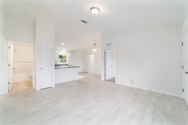 37 Teak Run, Ocala, FL 34472 - unfurnished living room featuring lofted ceiling and light wood-type flooring