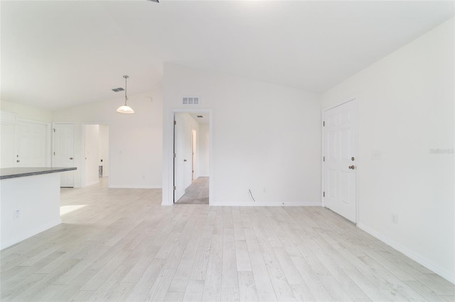 37 Teak Run, Ocala, FL 34472 - unfurnished living room with light wood-style flooring and lofted ceiling