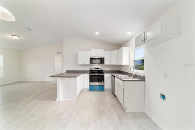 37 Teak Run, Ocala, FL 34472 - kitchen with stainless steel appliances, dark countertops, vaulted ceiling, open floor plan, and white cabinets