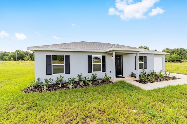 14690 SW 24th Pl, Ocala, FL 34481 - view of front facade featuring a garage, a front yard, and stucco siding