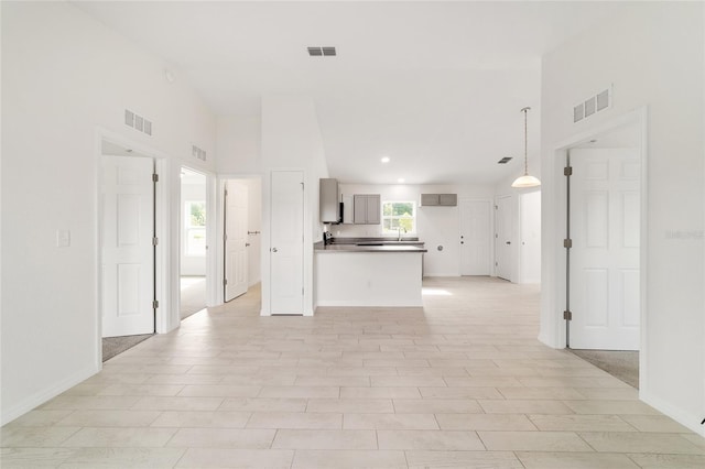 14690 SW 24th Pl, Ocala, FL 34481 - kitchen featuring a peninsula, recessed lighting, open floor plan, gray cabinets, and a high ceiling