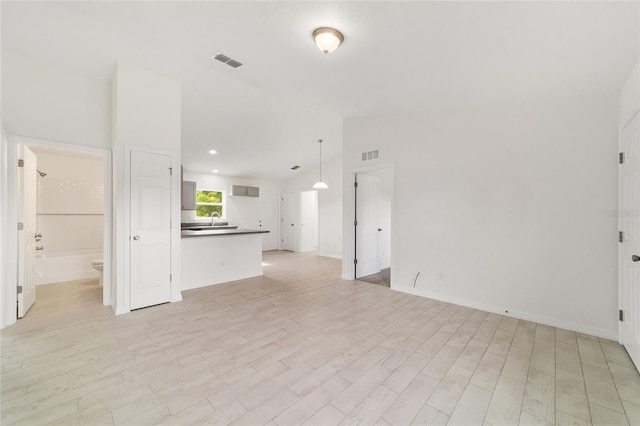 14690 SW 24th Pl, Ocala, FL 34481 - unfurnished living room featuring vaulted ceiling, light wood-style flooring, and recessed lighting