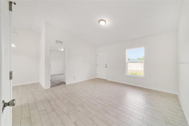 14690 SW 24th Pl, Ocala, FL 34481 - empty room with light wood-type flooring and lofted ceiling