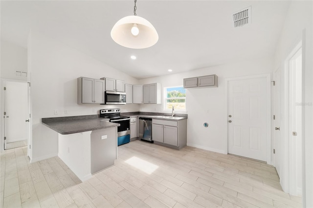 14690 SW 24th Pl, Ocala, FL 34481 - kitchen featuring appliances with stainless steel finishes, gray cabinets, a peninsula, dark countertops, and vaulted ceiling