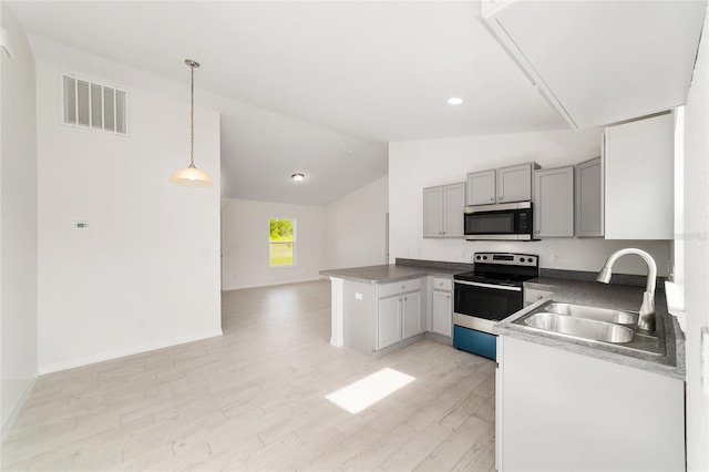 14690 SW 24th Pl, Ocala, FL 34481 - kitchen featuring stainless steel appliances, light wood-style floors, vaulted ceiling, gray cabinetry, and pendant lighting