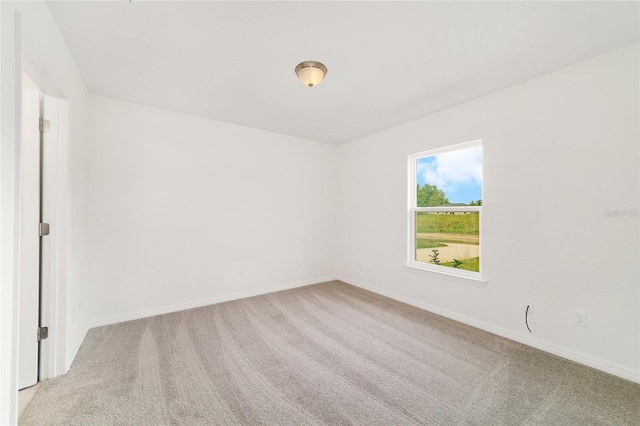 14690 SW 24th Pl, Ocala, FL 34481 - spare room featuring light colored carpet and baseboards