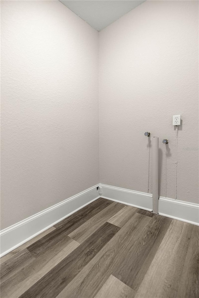 4609 NE 7th St, Ocala, FL 34470 - washroom with dark wood-type flooring and hookup for a washing machine