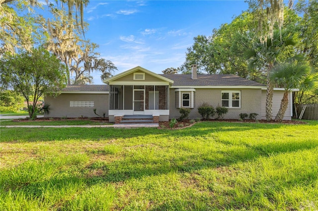 4609 NE 7th St, Ocala, FL 34470 - single story home featuring a sunroom, brick siding, and a front yard