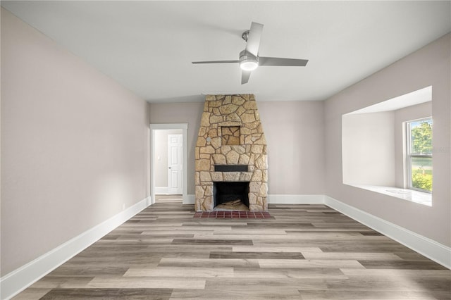 4609 NE 7th St, Ocala, FL 34470 - unfurnished living room with a ceiling fan, wood finished floors, and a fireplace