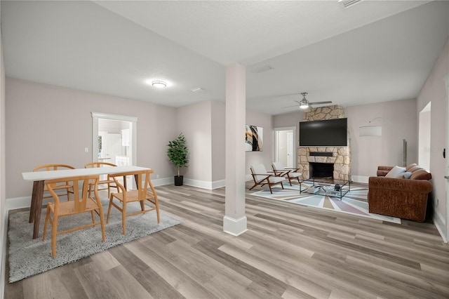 4609 NE 7th St, Ocala, FL 34470 - dining area featuring a stone fireplace, a ceiling fan, and light wood-style floors