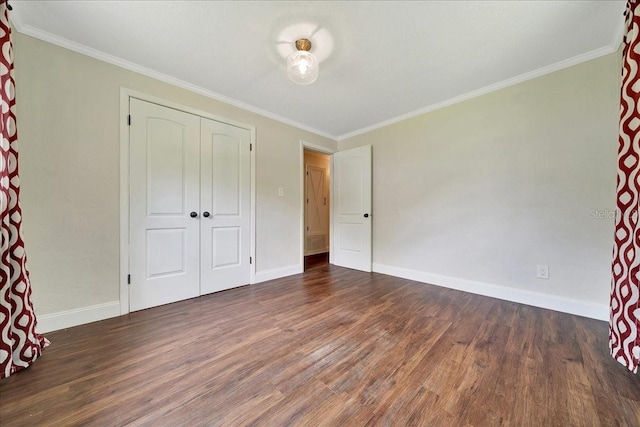6511 SE 25th Ave, Ocala, FL 34480 - unfurnished bedroom with dark wood-style flooring, crown molding, baseboards, and a closet