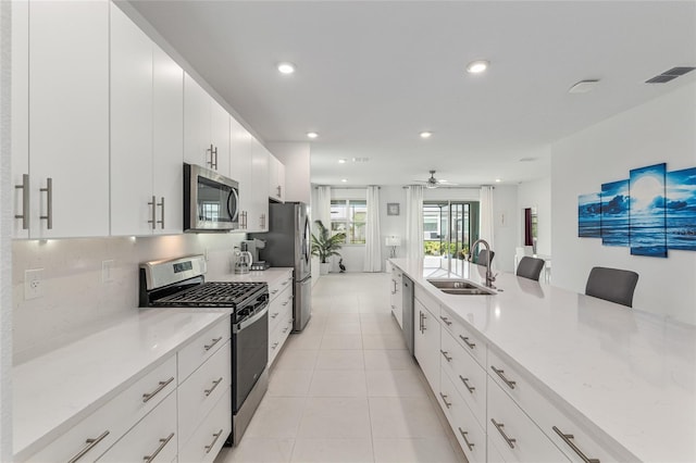 8802 SW 79th Loop, Ocala, FL 34481 - kitchen with stainless steel appliances, a sink, light tile patterned floors, white cabinets, and recessed lighting
