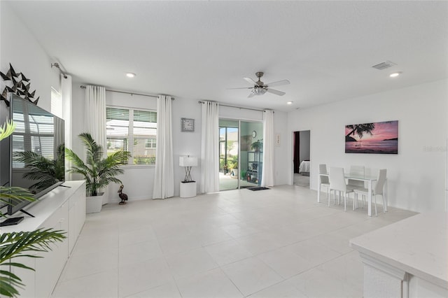8802 SW 79th Loop, Ocala, FL 34481 - living room featuring ceiling fan, recessed lighting, light tile patterned flooring, and baseboards