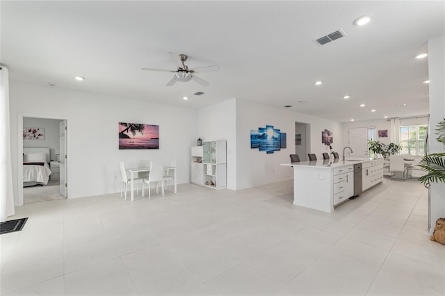 8802 SW 79th Loop, Ocala, FL 34481 - kitchen featuring open floor plan, ceiling fan, a kitchen island with sink, white cabinetry, and recessed lighting