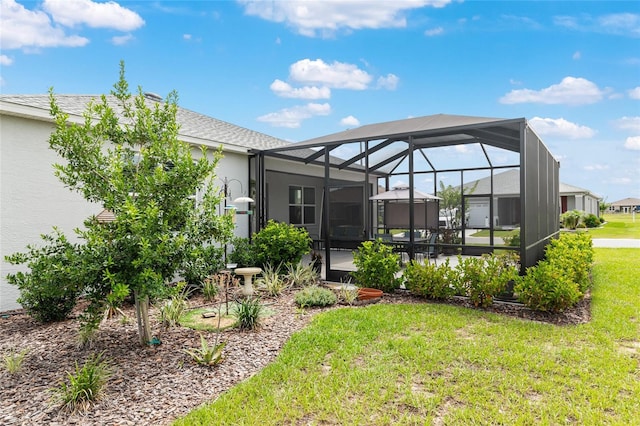 8802 SW 79th Loop, Ocala, FL 34481 - back of house with a lawn, glass enclosure, a patio, and stucco siding