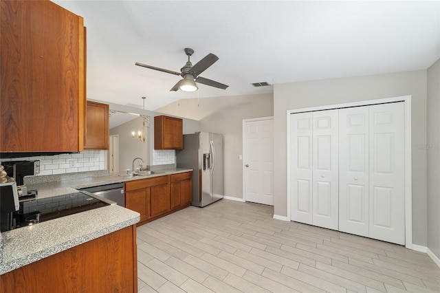 16605 SW 31st Cir, Ocala, FL 34473 - kitchen with appliances with stainless steel finishes, brown cabinets, ceiling fan, backsplash, and light countertops