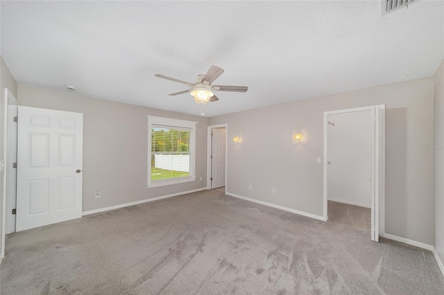 16605 SW 31st Cir, Ocala, FL 34473 - unfurnished bedroom featuring carpet floors, a ceiling fan, and a walk in closet
