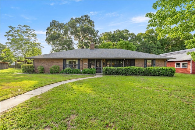 6497 W Anthony Rd, Ocala, FL 34479 - ranch-style home with brick siding, a chimney, and a front yard