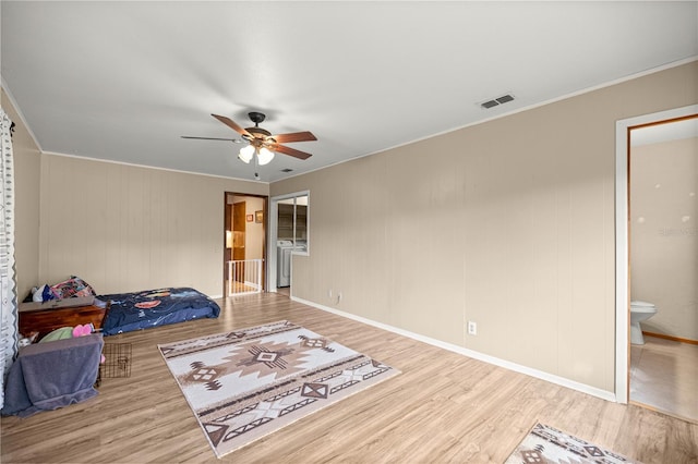 6497 W Anthony Rd, Ocala, FL 34479 - unfurnished bedroom with wood finished floors, crown molding, connected bathroom, ceiling fan, and baseboards