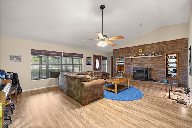 6497 W Anthony Rd, Ocala, FL 34479 - living area featuring vaulted ceiling, wood finished floors, a fireplace, ceiling fan, and baseboards